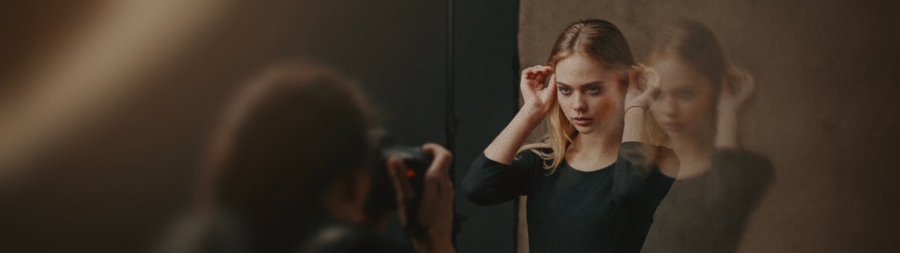 Photographer shooting a model against a paper backdrop