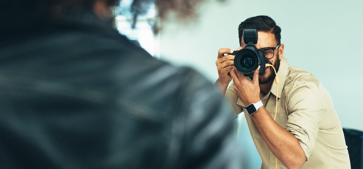 Photographer shooting a model on a studio set