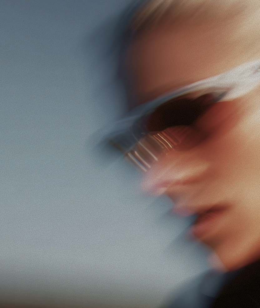 A model in sunglasses, blurred by motion